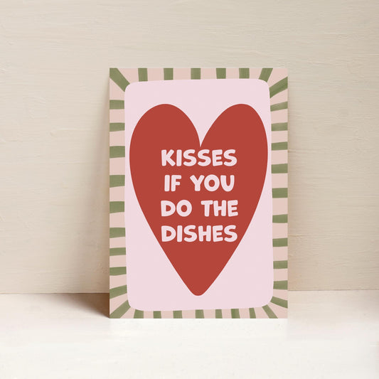 A4 sized art print with a striped border and a red heart in the center, with the text 'Kisses if you do the dishes' printed inside the heart shape.