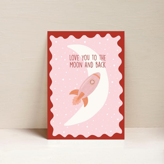 A4 unframed art print with a pink background featuring a rocket and the phrase 'Love you to the moon and back' printed at the top.